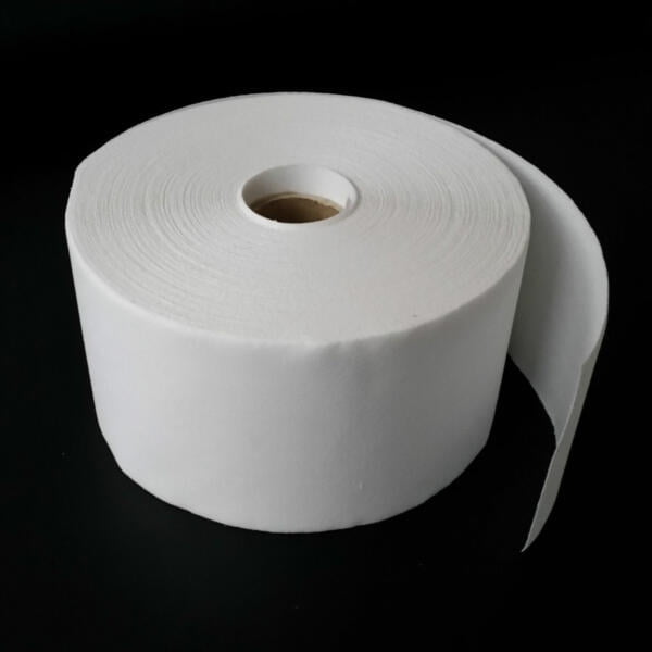A large, white, unspooled roll of toilet paper against a dark background. The end of the roll is slightly unrolled and hanging down. The paper appears smooth and thick, and the cardboard core is visible.