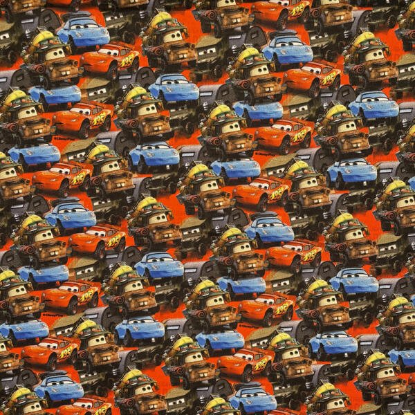 A colorful pattern featuring multiple characters from the "Cars" animated movie series. The pattern includes overlapping images of various anthropomorphic cars with expressive faces, showcasing characters in different colors like red, blue, and brown.