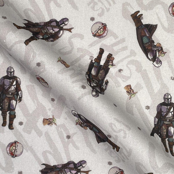 A fabric showcasing repeated patterns of a Mandalorian character in armor, and a small creature known as Baby Yoda in different poses and scenarios. The background is light gray with subtle decorative elements.