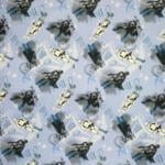 A patterned fabric featuring illustrations in a repeated design. The images include characters resembling armored warriors and robots against a light blue backdrop with "MANDO" written in different orientations. The color scheme includes shades of blue, white, and grey.
