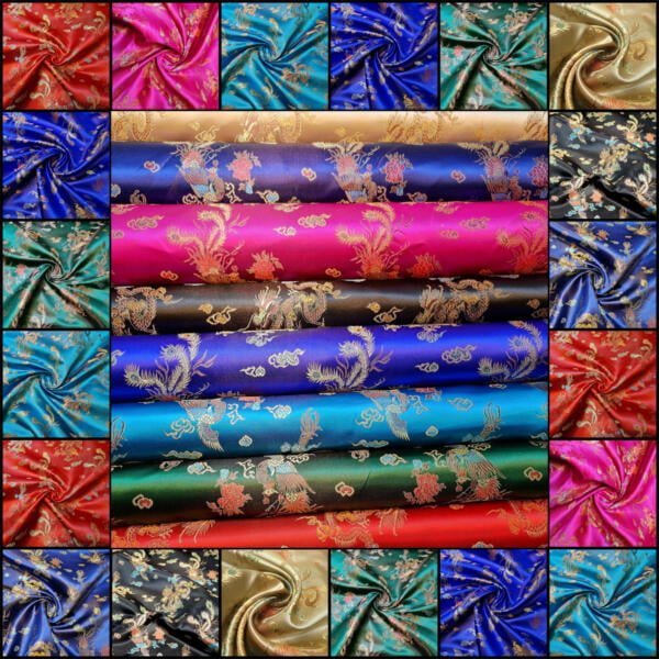 A collage of various colorful satin fabrics with intricate floral and paisley patterns. The image showcases rolled and folded fabric pieces in vibrant hues, including blue, red, green, gold, and purple, highlighting their glossy textures and detailed designs.