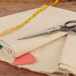 Canvas Fabric being shown in greater detail in a sewing room with craft scissors.