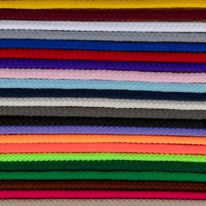 A stack of colorful braided cords arranged horizontally in rows. Colors include red, yellow, white, blue, purple, pink, black, gray, brown, green, orange, and more. Each cord's intricate braided pattern is visible, creating a textured and vibrant visual.