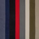 Vertical stripes of various colors, including shades of gray, blue, black, red, light beige, and olive green, aligned closely together. This pattern appears on a textured fabric surface.