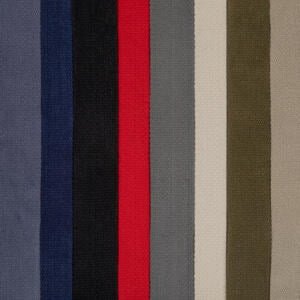 Vertical stripes of various colors, including shades of gray, blue, black, red, light beige, and olive green, aligned closely together. This pattern appears on a textured fabric surface.