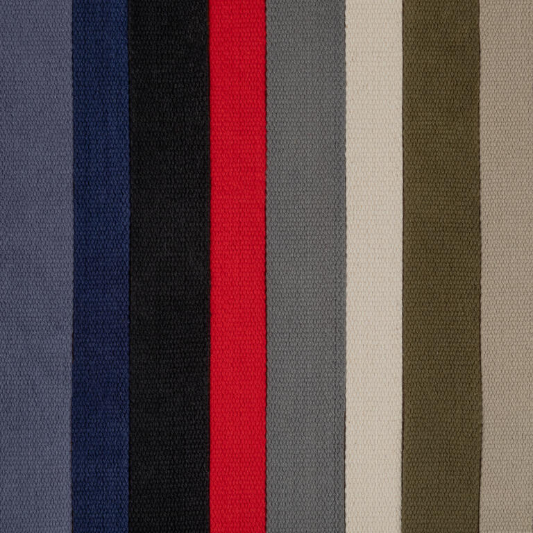 Vertical stripes of various colors, including shades of gray, blue, black, red, light beige, and olive green, aligned closely together. This pattern appears on a textured fabric surface.