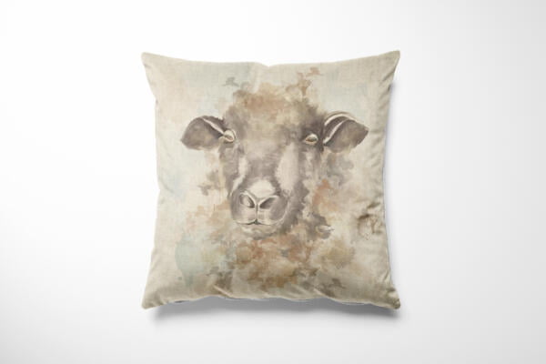 A decorative pillow with a pastel-toned watercolor painting of a sheep's head on its front. The background of the pillow is light beige, complementing the soft, muted colors of the sheep illustration. The pillow sits against a plain white background.