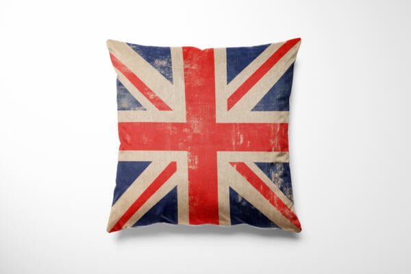A square cushion featuring a worn and vintage-style Union Jack flag design is displayed against a plain white background. The flag's colors are muted with visible signs of aging, giving it a rustic and nostalgic appearance.