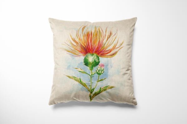 A decorative throw pillow with a nature-inspired design featuring an artistic illustration of a thistle flower in vibrant red, orange, yellow, and green hues. The background is light-colored, providing contrast to the vivid colors of the floral artwork.