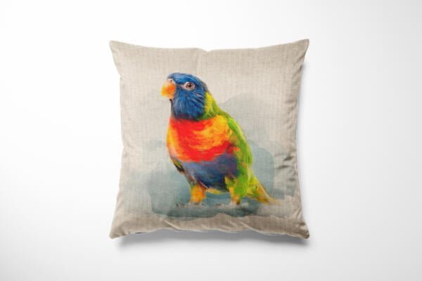 A decorative pillow featuring a realistic illustration of a colorful parrot. The parrot has vibrant plumage with a blue head, orange beak, and a mix of green, yellow, and red on its body. The background of the pillow is a light, neutral color.