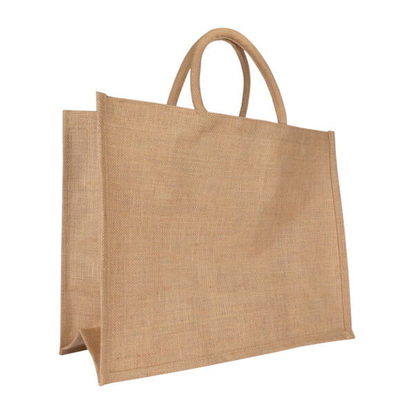A plain, large rectangular jute tote bag with two short, rounded handles. The bag has a natural, beige color and a simple, sturdy design, suitable for carrying groceries or other items. The fabric has a coarse, woven texture.