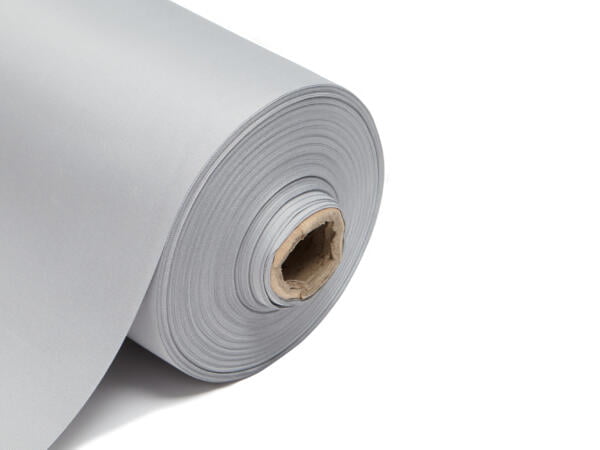 This image shows a roll of blackout lining fabric. The fabric is neatly rolled around a central cardboard tube, revealing multiple layers tightly wound together. The fabric has a smooth, matte finish and is displayed on a clean, white background that emphasizes its uniform color and texture. The edge of the roll is cleanly cut, highlighting the fabric's thickness and durability. The colour of this lining is grey