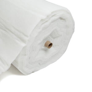 A large roll of white, fluffy batting material is shown against a plain white background. The roll is partially unrolled, revealing the soft, fibrous texture of the material, with a cardboard tube at the center.