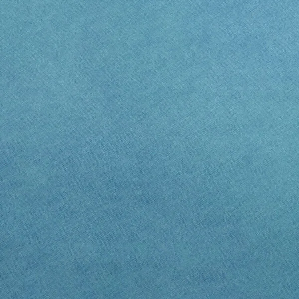 A close-up of the 100% Cotton Fabric reveals a smooth, textured surface with a subtle woven pattern. The fabric's light and medium blue blend creates a calm, uniform appearance, ideal for lifestyle projects.