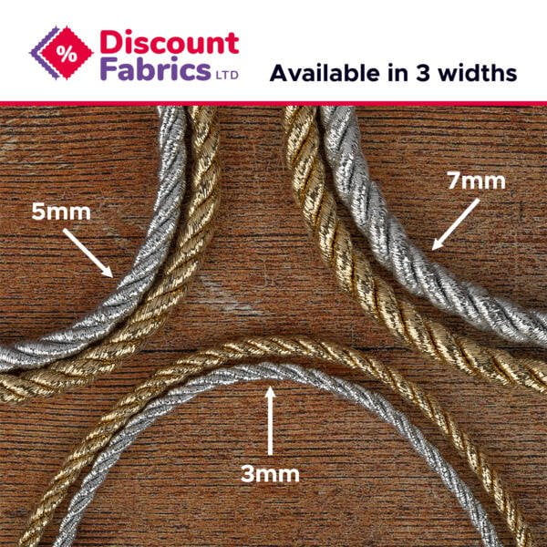 A wooden surface with twisted metallic cords in three different widths: 3mm, 5mm, and 7mm. The cords are color-coded: gold for 3mm, silver for 5mm, and a mix of silver and gold for 7mm. The logo of Discount Fabrics LTD is in the top left corner. Text reads "Available in 3 widths.