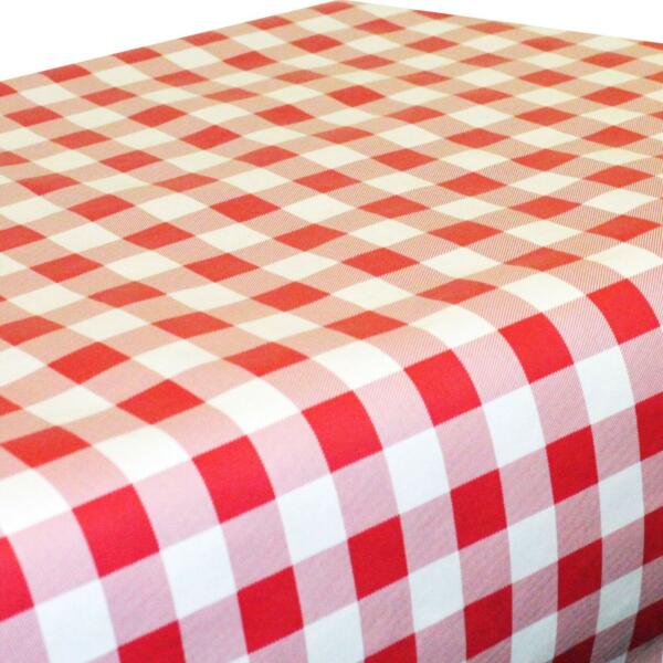 A table is covered with a red and white checkered tablecloth featuring a classic gingham pattern. The checkered squares are evenly spaced and create a bright, inviting appearance.