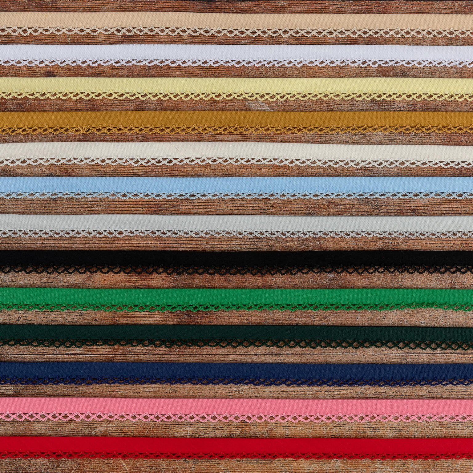 A collection of various colorful lace trims arranged in horizontal rows. The laces are in shades of brown, yellow, green, blue, pink, and other colors, each featuring intricate patterns and designs.