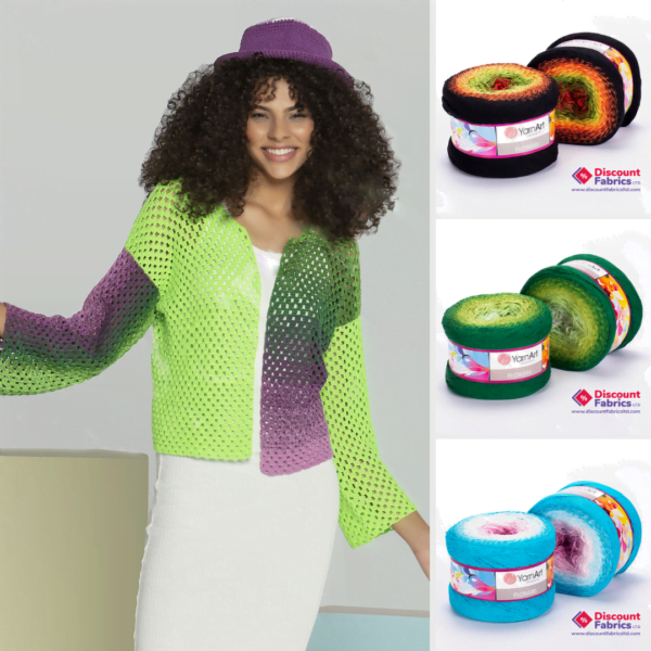 A smiling woman with curly hair wears a gradient crocheted cardigan and a purple hat. To the right, three colorful yarn spools in orange-black, green, and blue-pink are displayed, each labeled "Yarn Art" and featuring the "Discount Fabrics" logo.