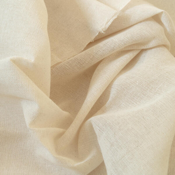 A close-up of a piece of off-white, textured fabric that appears to be linen. The material is slightly wrinkled and draped in soft folds, highlighting its weave and natural texture. A few frayed threads can be seen along the top edge.