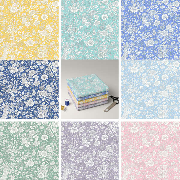 A grid of nine patterned fabrics in various colors, each with white floral designs. Colors include yellow, turquoise, light blue, blue, dark blue, green, gray, pink, and purple. In the center, a stack of folded fabrics with a blue thread spool and a measuring tape.