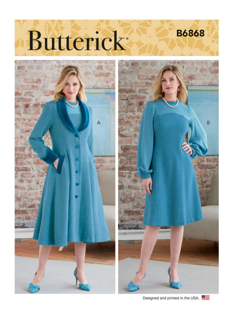 Butterick sewing pattern B6868 features a woman modeling two outfits. Outfit A is a blue, buttoned coat with lapels and long sleeves. Outfit B is a blue dress with sheer long sleeves and a gathered waist. She is standing in a room with a brick wall background.