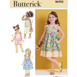 Butterick sewing pattern B6952 featuring designs for children's clothing. The cover displays four variations: a sleeveless floral dress, a pink playsuit, a floral top and skirt, and a yellow romper. A young girl models the sleeveless floral dress on the right.