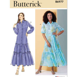 Butterick pattern B6977: Two women modeling long-sleeve maxi dresses. Illustration B shows a woman in a purple shirt dress with tiered skirt. Photo A features a woman in a light blue patterned dress with a similar tiered design.