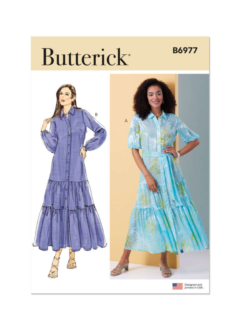 Butterick pattern B6977: Two women modeling long-sleeve maxi dresses. Illustration B shows a woman in a purple shirt dress with tiered skirt. Photo A features a woman in a light blue patterned dress with a similar tiered design.