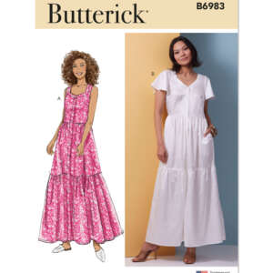 Butterick pattern B6983 envelope showing two dress designs. Design A illustrates a woman with curly hair wearing a sleeveless, tiered, pink floral dress. Design B shows a photo of a woman wearing a white, short-sleeved, tiered maxi dress.