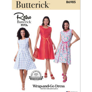 Sewing pattern cover for Butterick B6985, featuring three women modeling the "Wrap-and-Go Dress" in different fabrics: light blue plaid, solid red, and floral. Includes a "Retro Butterick 1970's" label and a stamp indicating a three-piece pattern.