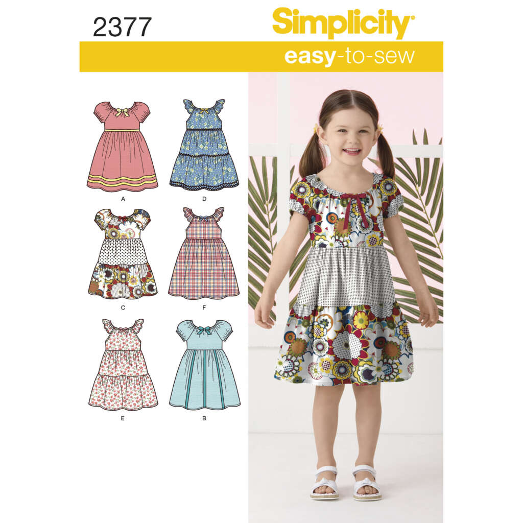 Cover of a Simplicity sewing pattern labeled 2377 for "easy-to-sew" girls' dresses. The image features a happy girl wearing a dress made from the pattern, and illustrations of various dress designs labeled A to F, showcasing different styles and fabrics.