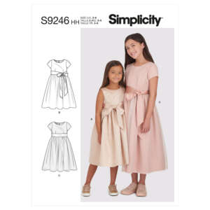 Two young girls are modeling dresses from Simplicity sewing pattern S9246. Both wear dresses with short sleeves and large front bows, one in light pink (View C) and the other in beige (View A). The pattern also shows schematic diagrams for two additional views (B and C).