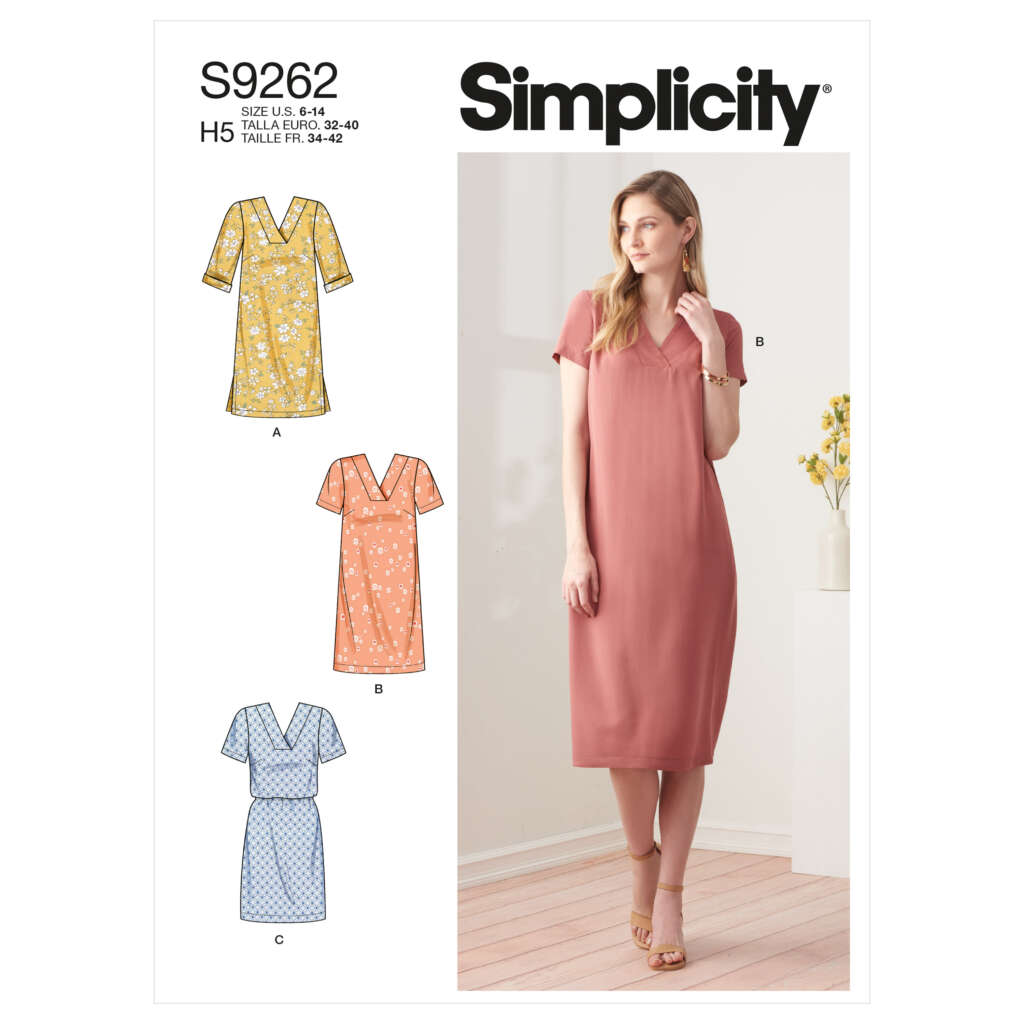 Sewing pattern S9262 from Simplicity, featuring a woman wearing a pink knee-length dress (view B). Additional views A, B, and C show the dress in different fabrics, each with short sleeves and V-neck designs. Ideal for sizes 6-14 and 14-22.