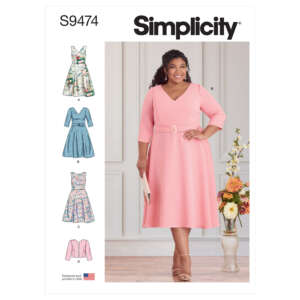 Simplicity sewing pattern S9474 featuring a woman in a pink dress (option B) with a V-neckline and a belt. Additional dress variations (A, C) and a jacket (D) are illustrated on the left. A vase with flowers is in the background.