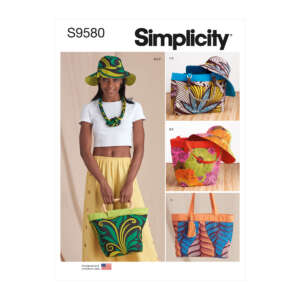 Cover of Simplicity pattern S9580 showing a woman wearing a brightly patterned hat and scarf, holding a tote bag. To the right, there are images of different hats and bags made with vibrant, colorful prints. The "Designed and Printed in the USA" logo is at the bottom left.