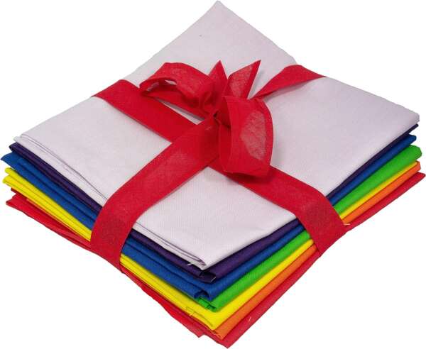 A stack of colorful fabric squares, including white, purple, blue, green, yellow, and red, neatly folded and tied together with a red ribbon, creating a visually appealing bundle.