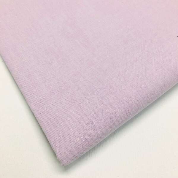 A close-up of a folded piece of light lavender fabric with a smooth, even texture. The fabric is laid out on a white surface.