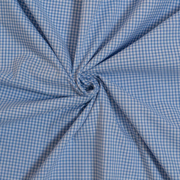 Close-up of blue and white gingham fabric, twisted at the center into a spiral pattern. The fabric features a small checkered design, with alternating light blue and white squares. The texture appears soft and slightly wrinkled.