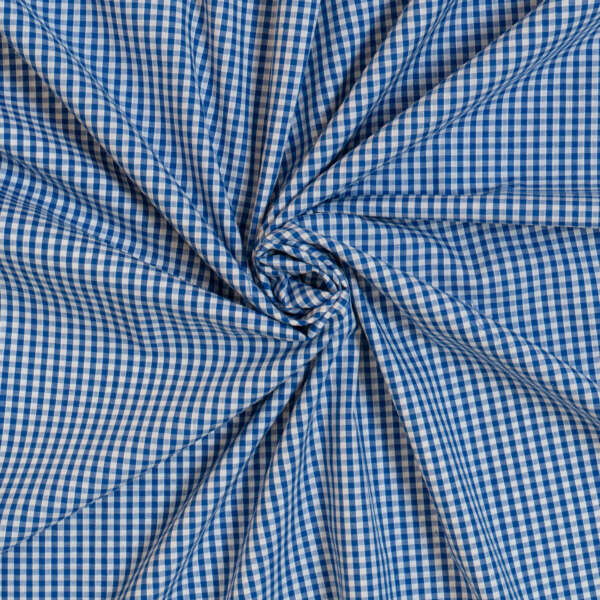 An image of blue and white gingham fabric, neatly arranged in a spiral pattern. The fabric features a small, checkered design, creating a visually appealing, symmetrical swirl effect at the center of the image.