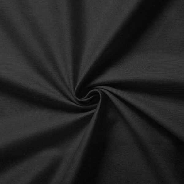 A close-up view of a black fabric with a swirling pattern at the center, creating a radial design. The texture appears smooth, with subtle folds converging towards the middle.