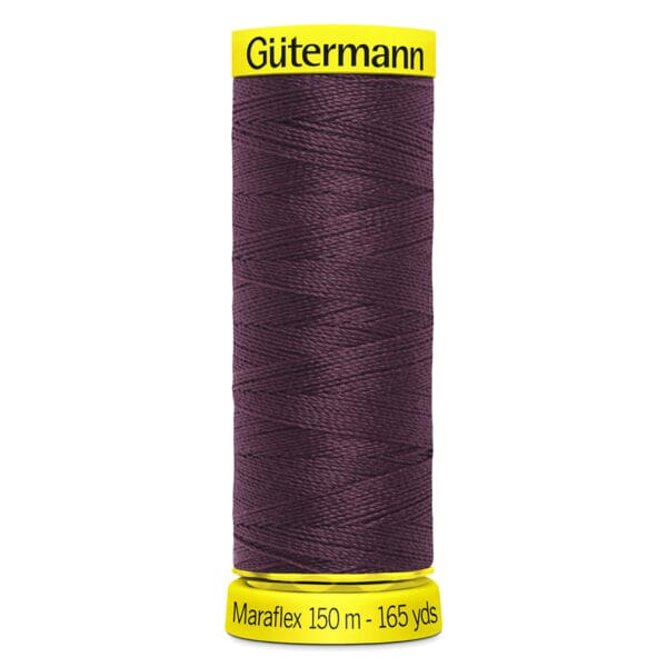 A spool of Gütermann Maraflex thread, 150 meters (165 yards) long, in a dark purple color. The spool has a bright yellow base and top, with the brand and length clearly labeled in black text.