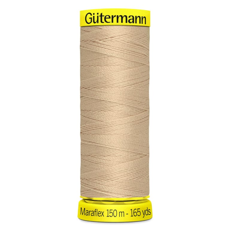 A spool of Gütermann Maraflex thread, 150 meters (165 yards), in beige color. The spool has yellow ends with the brand name printed on the top and measurement details on the bottom.