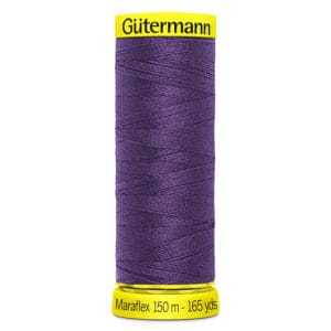 Spool of Gütermann Maraflex thread in deep purple. The label reads "150 m - 165 yds" on a yellow base.
