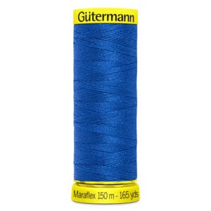 A spool of Gütermann Maraflex thread in royal blue. The label is bright yellow, showing "Gütermann" at the top and "Maraflex 150 m - 165 yds" at the bottom. The thread is neatly wound around the spool.