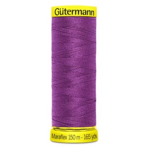 A purple spool of Gütermann Maraflex thread. The spool features a yellow cap and base, with text indicating it is 150 meters (165 yards) long.