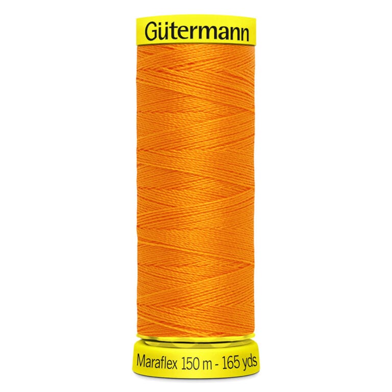 A spool of Gütermann Maraflex thread, bright orange, with labels stating 150 meters and 165 yards.