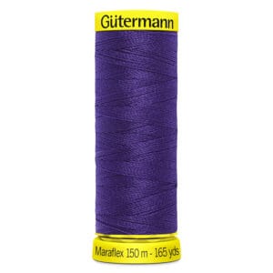 A spool of Gütermann Maraflex thread is displayed. The thread is a deep purple color. The top and bottom of the spool are yellow, with text indicating "Maraflex 150 m - 165 yds.