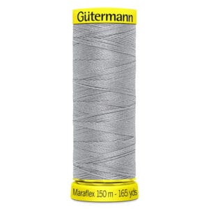 A spool of Gütermann Maraflex sewing thread in silver, wrapped tightly around a yellow base with black text indicating "Maraflex 150 m - 165 yds." The top of the spool is also yellow with the brand name "Gütermann" in black.