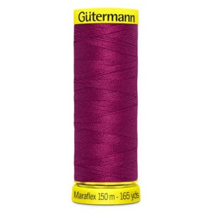 A spool of Gütermann Maraflex thread in deep red, shown vertically. The labels are bright yellow with black text indicating "Gütermann Maraflex 150 m - 165 yds." The thread is tightly wound around the spool.