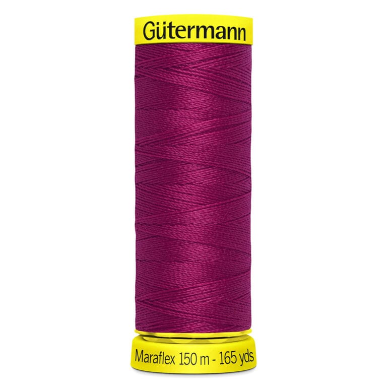 A spool of Gütermann Maraflex thread in deep red, shown vertically. The labels are bright yellow with black text indicating "Gütermann Maraflex 150 m - 165 yds." The thread is tightly wound around the spool.